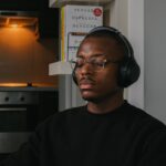 a man wearing headphones sitting in a chair